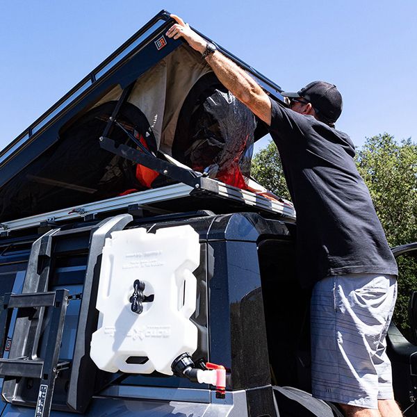 Man closing Convoy tent 