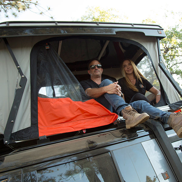 Man and woman sitting inside convoy tent